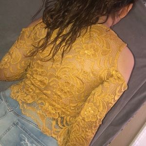 A laced high quality long sleeved yellowish shirt